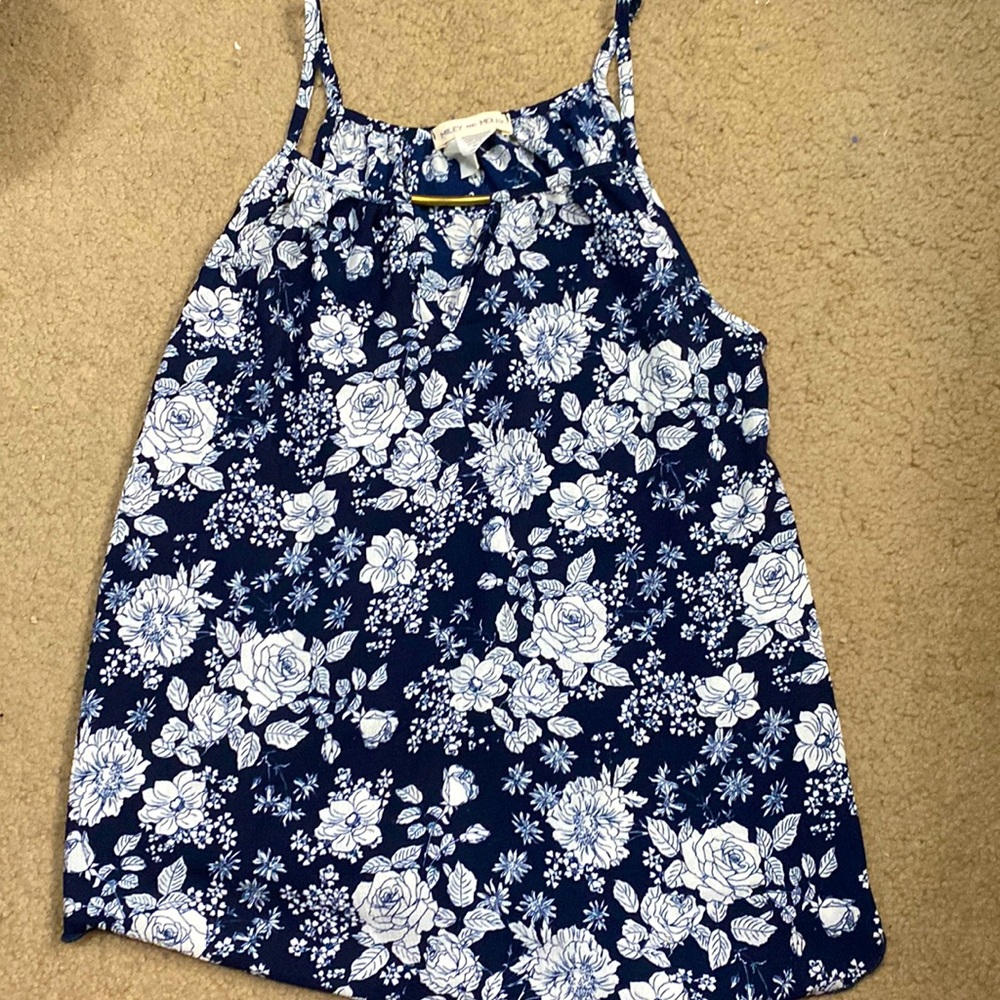 Small size tank top with floral print. Has a gold bar on the collar